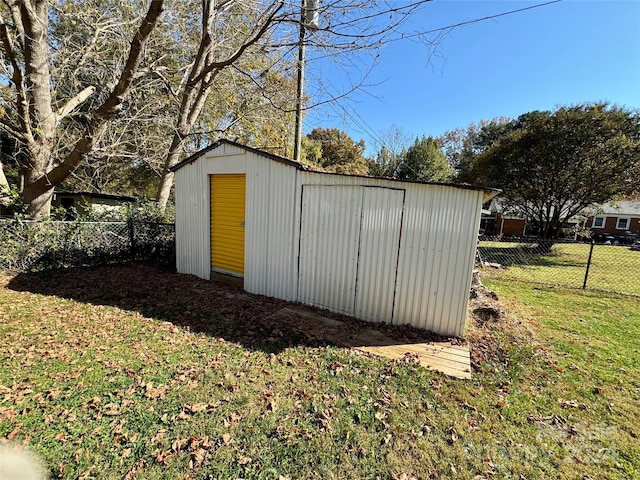 view of outbuilding featuring a lawn