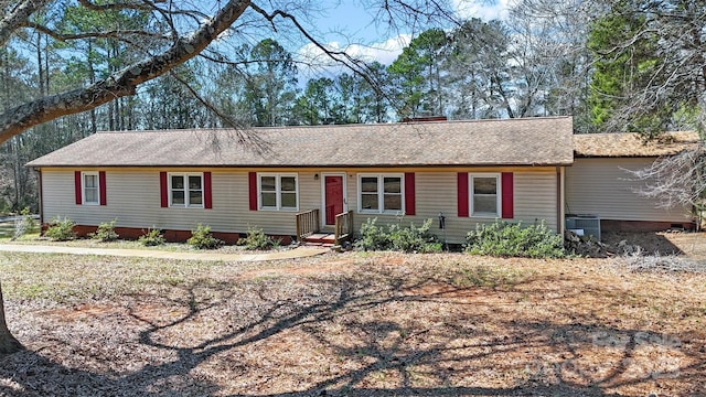 single story home featuring a shingled roof and central AC