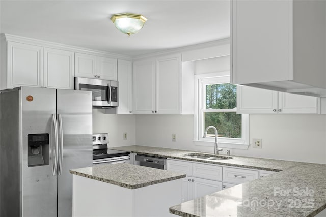 kitchen featuring a sink, stainless steel appliances, light stone countertops, and white cabinetry