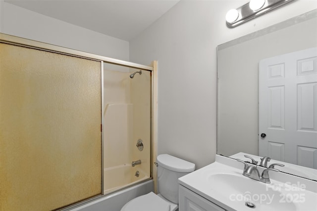 bathroom with toilet, vanity, and bath / shower combo with glass door