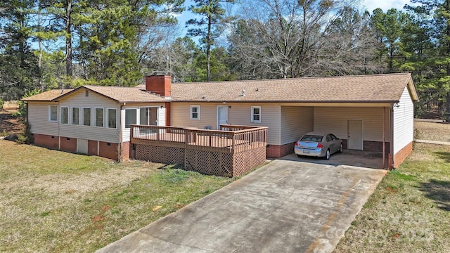 view of front facade featuring driveway, a front lawn, crawl space, a carport, and a chimney