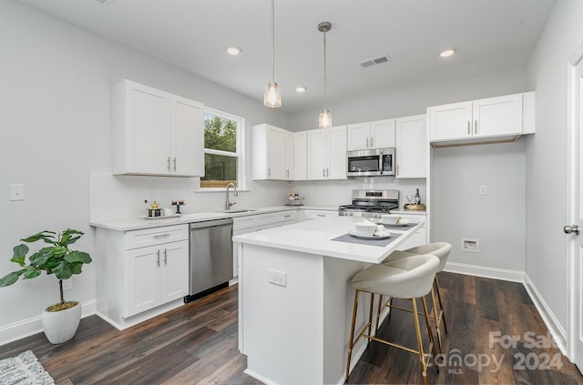 kitchen featuring stainless steel appliances, white cabinetry, and a kitchen island