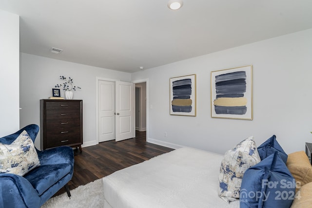 bedroom with dark hardwood / wood-style floors