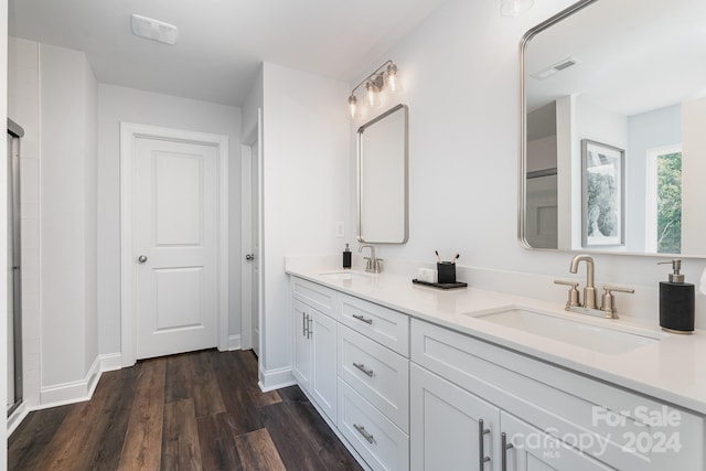 bathroom with wood-type flooring, vanity, and walk in shower