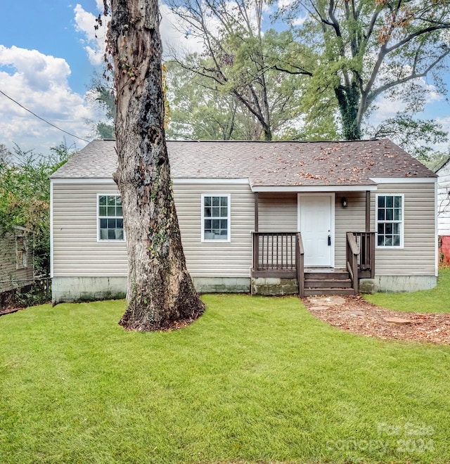 back of property featuring a yard