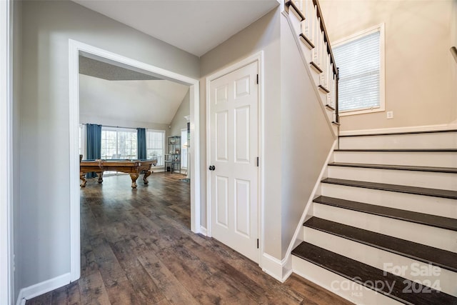 staircase featuring vaulted ceiling, pool table, and hardwood / wood-style floors