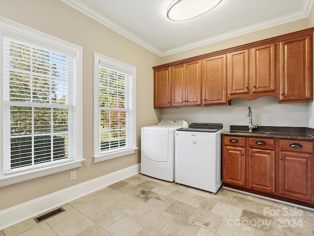 laundry area with cabinets, independent washer and dryer, sink, and crown molding