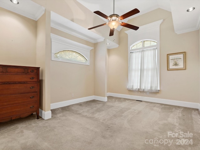 empty room featuring ornamental molding, light colored carpet, and plenty of natural light