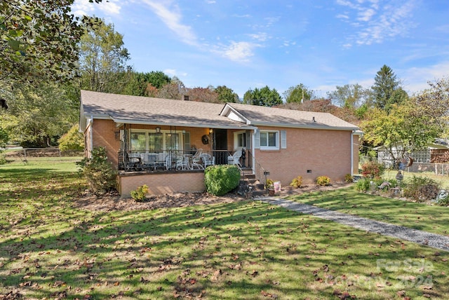 ranch-style home with a porch and a front lawn