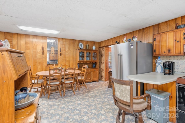 dining area featuring wooden walls