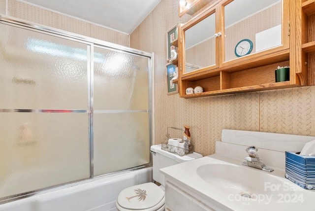 full bathroom featuring bath / shower combo with glass door, vanity, and toilet