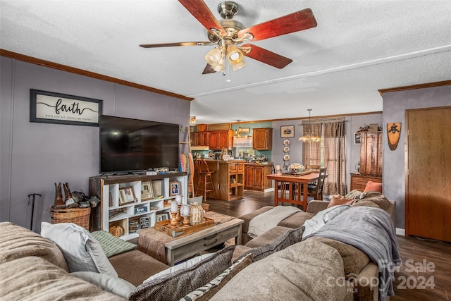 living room featuring ornamental molding, dark hardwood / wood-style flooring, and ceiling fan with notable chandelier