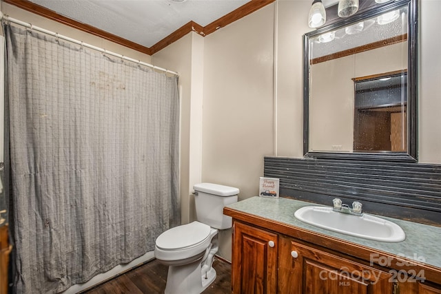 bathroom with hardwood / wood-style floors, toilet, ornamental molding, vanity, and a shower with curtain