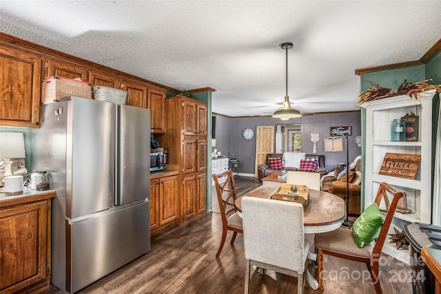 interior space with crown molding, stainless steel appliances, a textured ceiling, and dark hardwood / wood-style flooring