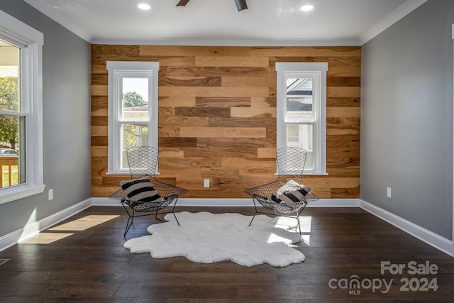 unfurnished room with ceiling fan, ornamental molding, wooden walls, and dark wood-type flooring