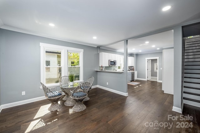 dining room with crown molding and dark wood-type flooring