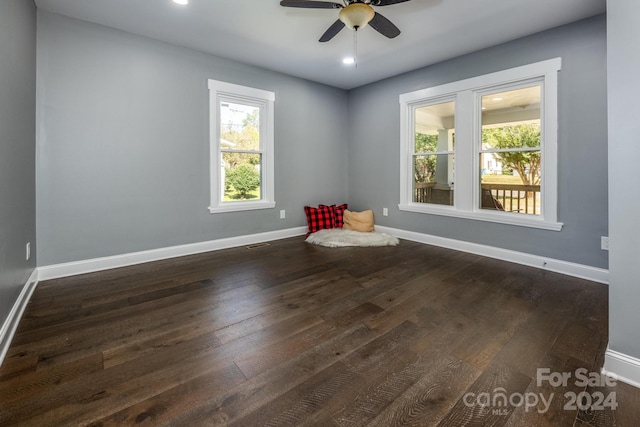 spare room with dark hardwood / wood-style floors and ceiling fan