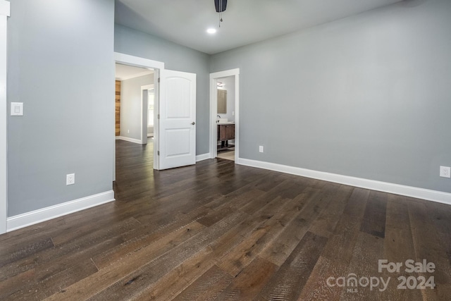 unfurnished room featuring ceiling fan and dark hardwood / wood-style floors