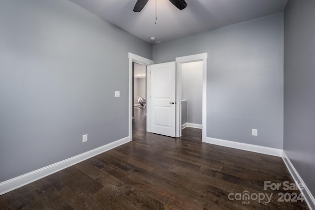 unfurnished bedroom featuring dark wood-type flooring and ceiling fan