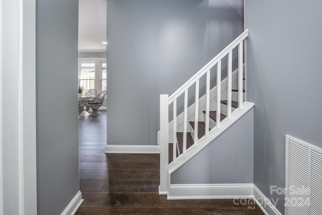 stairs featuring hardwood / wood-style flooring