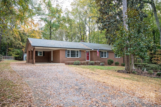 ranch-style house featuring a carport