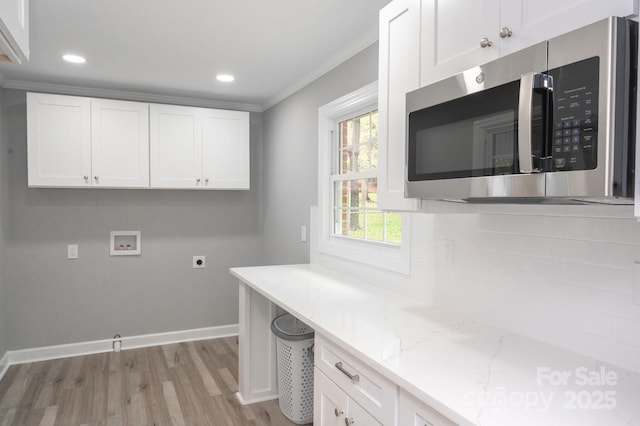 laundry room with washer hookup, crown molding, light hardwood / wood-style flooring, and hookup for an electric dryer