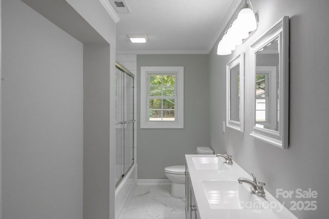 full bathroom featuring vanity, crown molding, shower / bath combination with glass door, and toilet