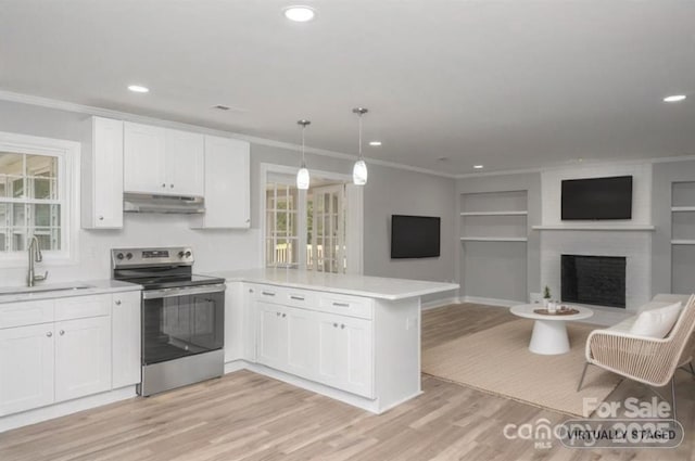 kitchen with decorative light fixtures, sink, white cabinets, electric range, and kitchen peninsula