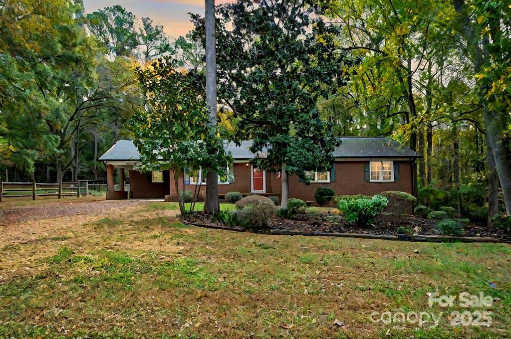 ranch-style home featuring a yard