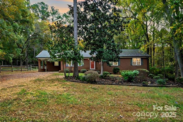 ranch-style home featuring a yard