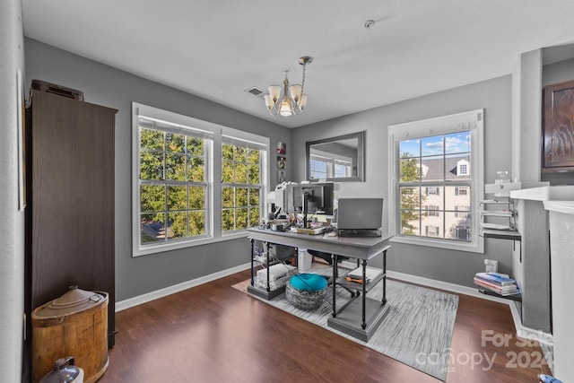 office area with dark wood-type flooring and a chandelier