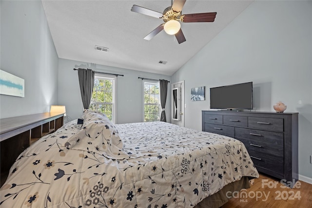 bedroom featuring ceiling fan, lofted ceiling, and light hardwood / wood-style floors