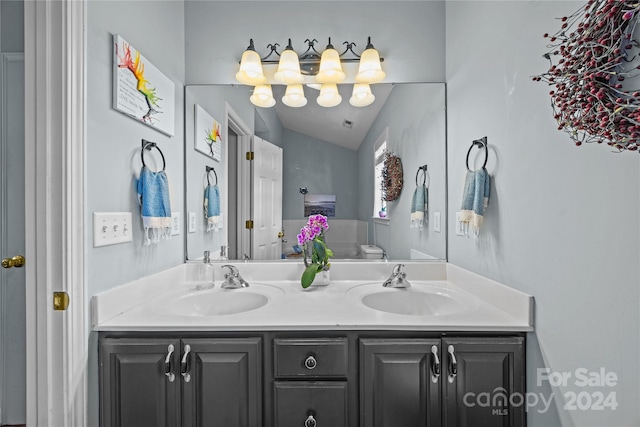 bathroom featuring vanity and vaulted ceiling