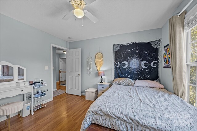 bedroom with hardwood / wood-style flooring and ceiling fan