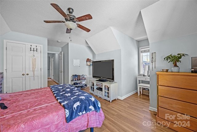 bedroom with a textured ceiling, wood-type flooring, a closet, and ceiling fan