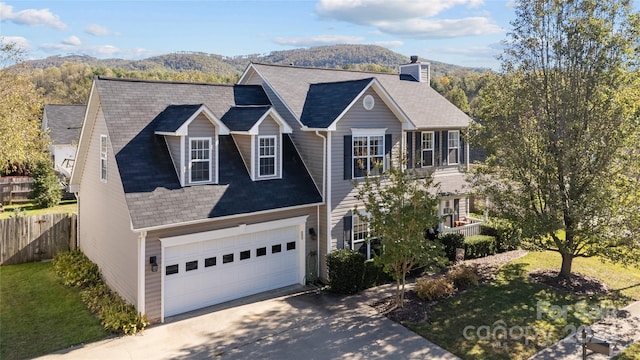 view of front facade featuring a mountain view and a garage