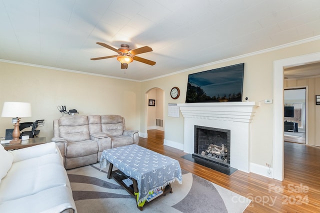 living room featuring hardwood / wood-style floors, ceiling fan, and ornamental molding