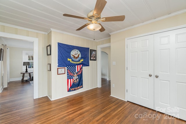 interior space with dark hardwood / wood-style floors and ornamental molding