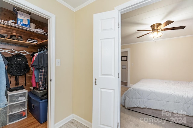 bedroom with a closet, ceiling fan, crown molding, and light hardwood / wood-style flooring