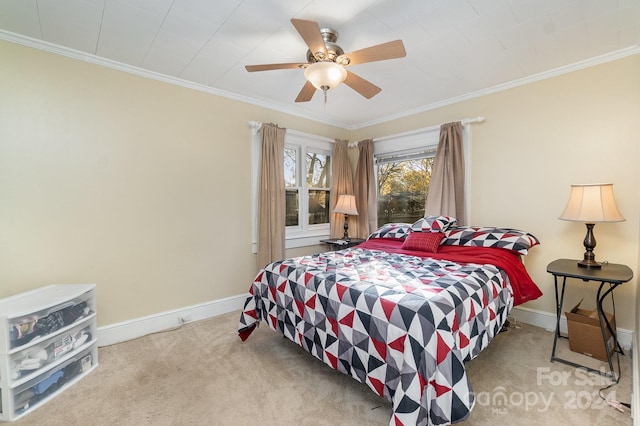 bedroom featuring ceiling fan, crown molding, and light colored carpet