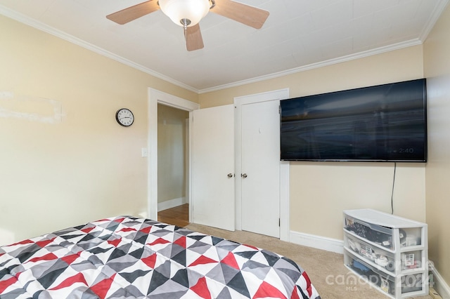 bedroom with carpet flooring, ceiling fan, and ornamental molding