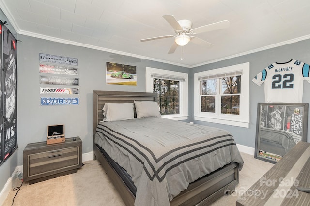 carpeted bedroom featuring ceiling fan and ornamental molding