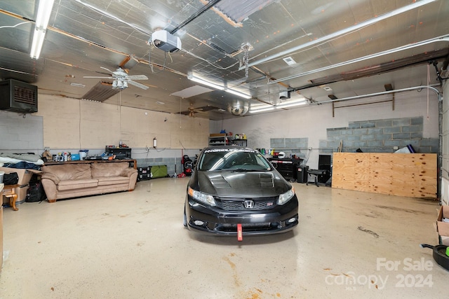 garage featuring a garage door opener and ceiling fan