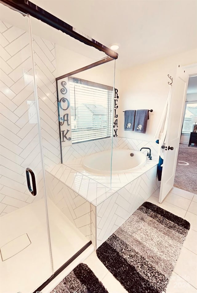 bathroom with tile patterned floors and plus walk in shower