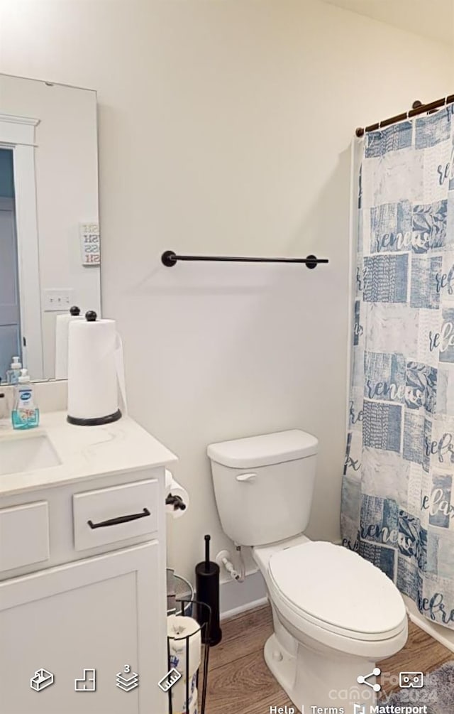 bathroom featuring vanity, a shower with shower curtain, wood-type flooring, and toilet