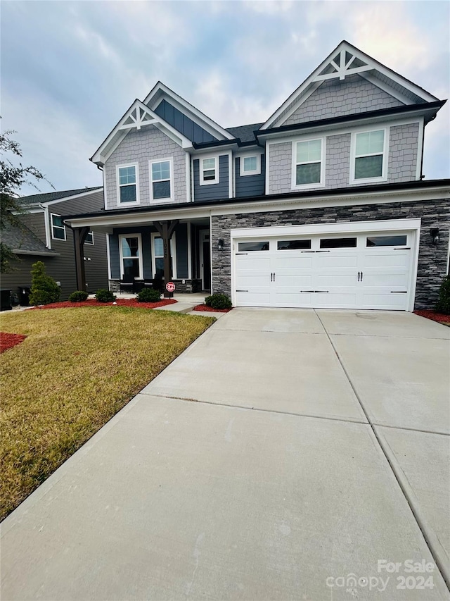 view of front of home with a front yard and a garage