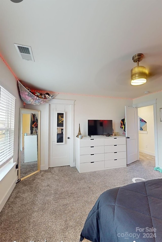 bedroom with light colored carpet and ceiling fan