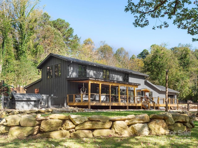 back of property with a wooden deck