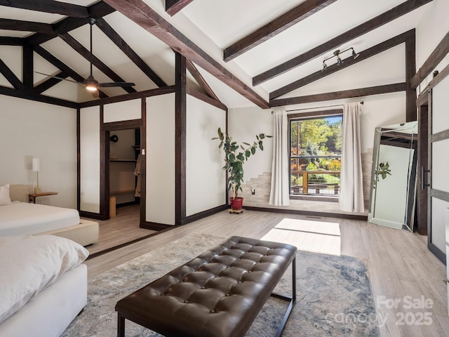 bedroom featuring high vaulted ceiling, beamed ceiling, and light wood-style flooring