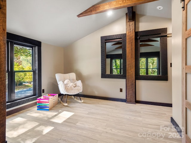 unfurnished room with lofted ceiling with beams, wood finished floors, and baseboards